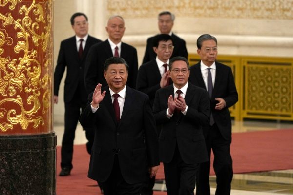 New members of the Politburo Standing Committee, front to back, President Xi Jinping, Li Qiang, Zhao Leji, Wang Huning, Cai Qi, Ding Xuexiang, and Li Xi arrive at the Great Hall of the People in Beijing, Sunday, Oct. 23, 2022. (AP Photo/Ng Han Guan)